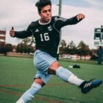 man wearing black and blue jersey shirt on field