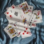 playing cards on blue textile