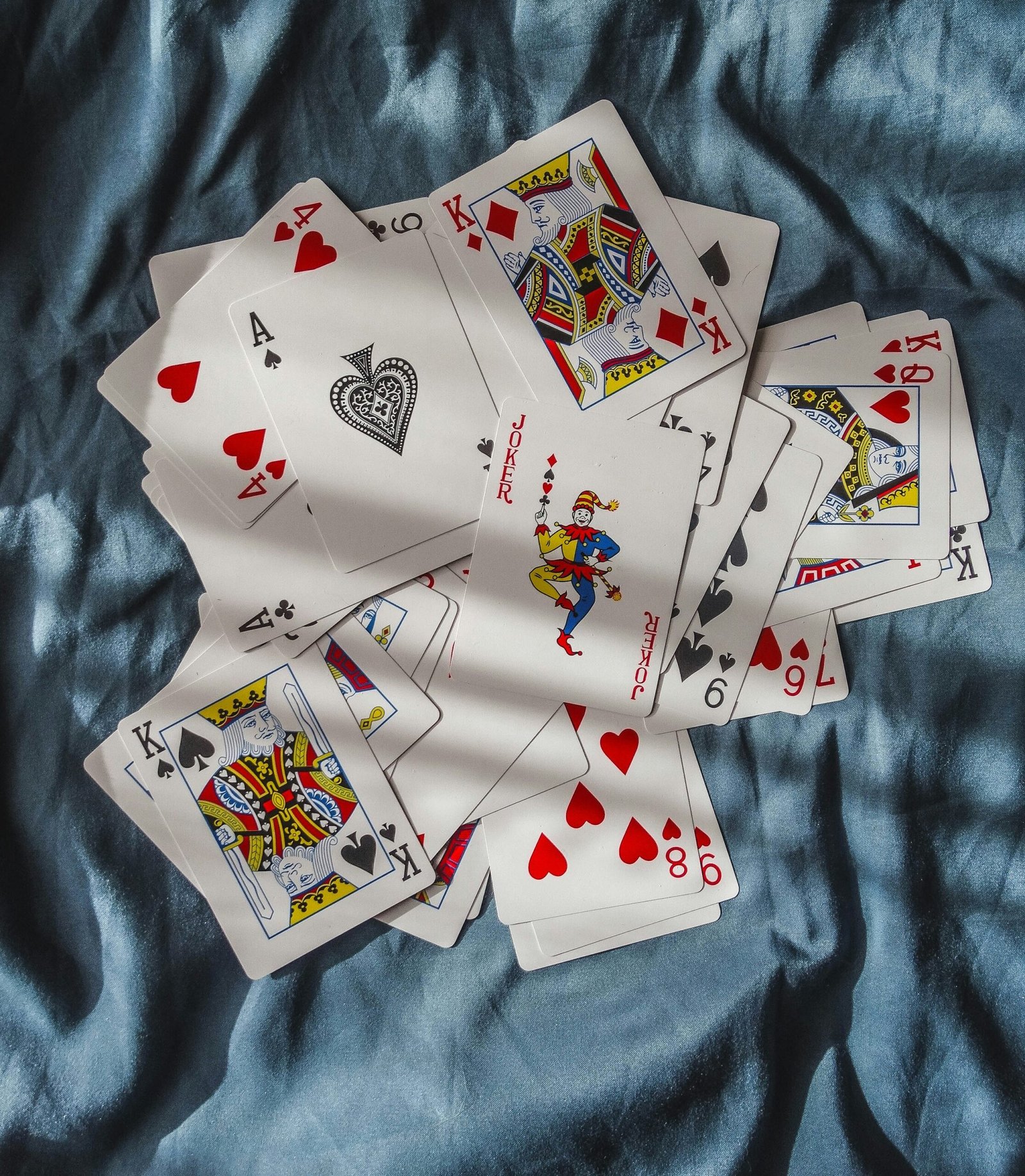 playing cards on blue textile